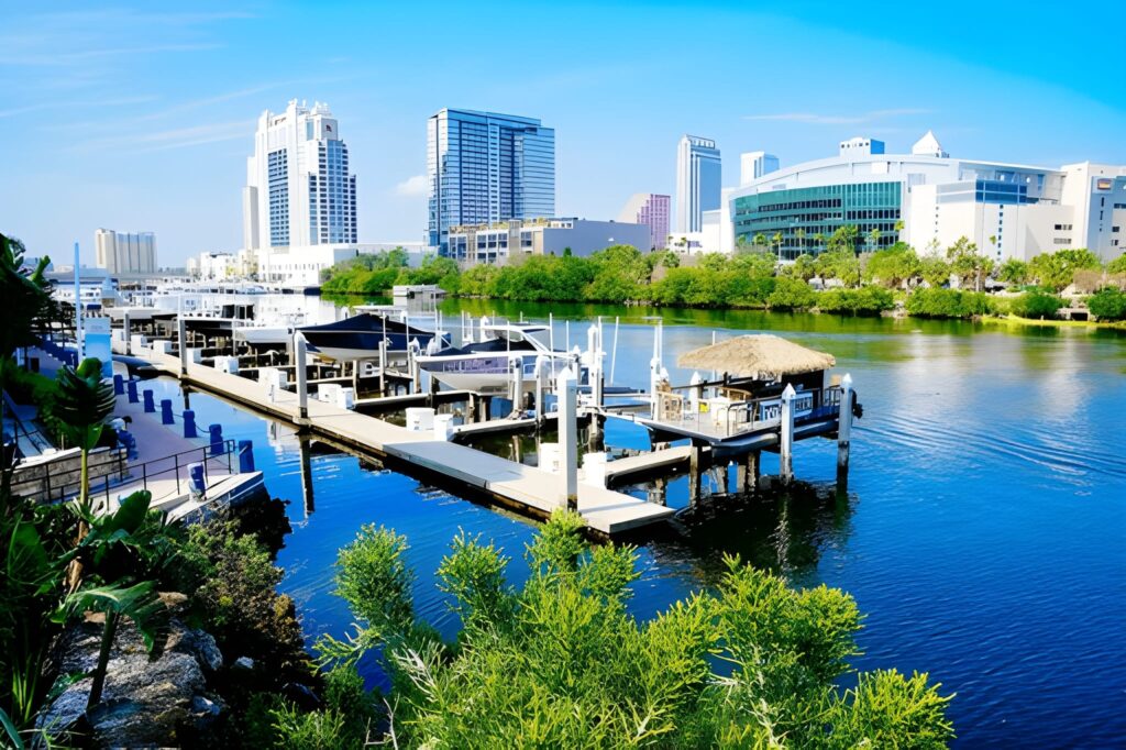 Tampa Bay Riverwalk with boats and city skyline at sunset