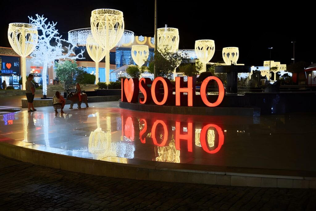 alt="Friends dining at a rooftop restaurant with New York City skyline in the background"